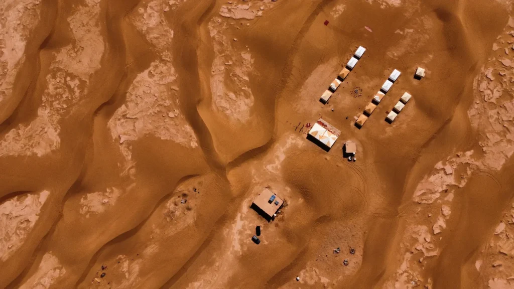 Remote Erg Chegaga-style camp seen from above among the dunes