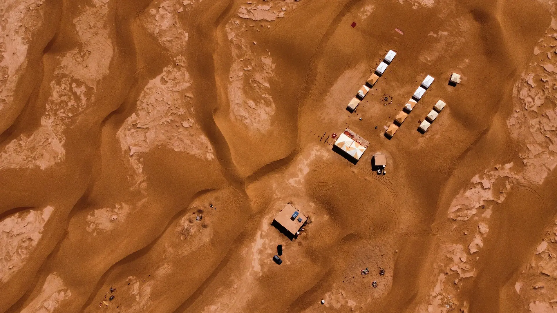 Remote Erg Chegaga-style camp seen from above among the dunes