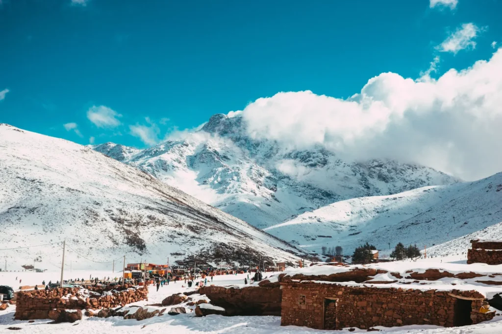 Snow-covered High Atlas Mountains under moving clouds