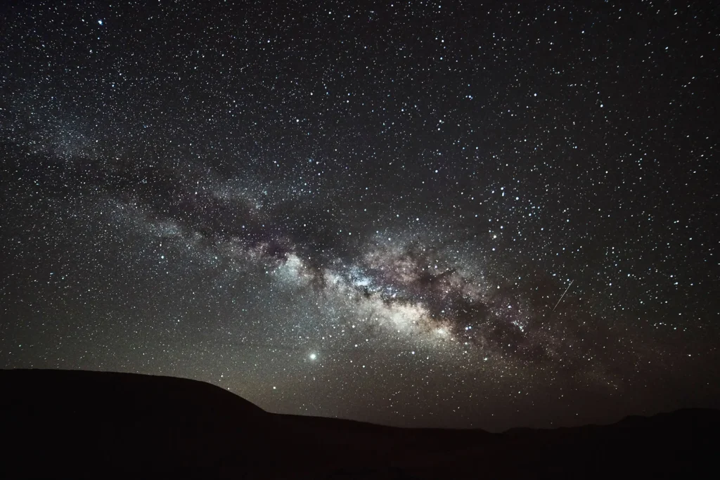 The Milky Way above the Sahara dunes on a clear night near M’hamid