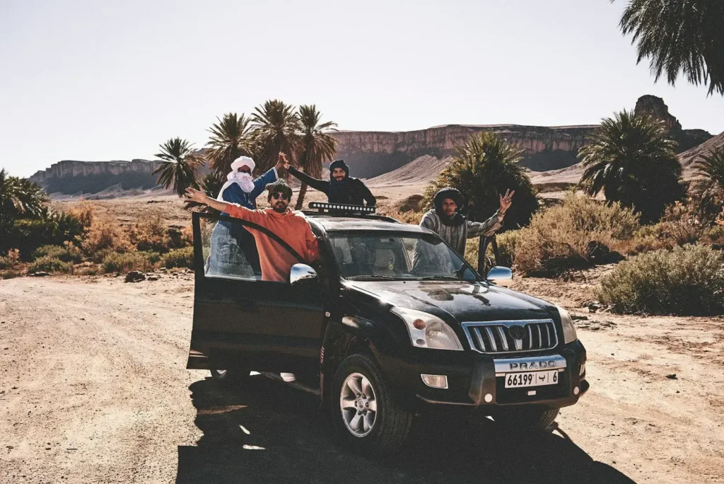 Guests and local guides beside a private 4x4 in southern Morocco
